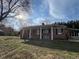 Well-maintained brick ranch with mature trees and front porch at 2117 George Winston Rd, Oxford, NC 27565