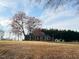 Brick ranch home with a covered parking area on a large grassy lot at 2117 George Winston Rd, Oxford, NC 27565