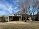 Side view of a brick house with a basketball hoop above the covered parking area at 2117 George Winston Rd, Oxford, NC 27565