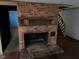 Brick fireplace with wood mantle next to steps to a different level at 2117 George Winston Rd, Oxford, NC 27565