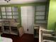 Kitchen with green cabinets, open shelving, and a stainless steel sink at 2117 George Winston Rd, Oxford, NC 27565