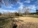 Sunny land featuring a vast field with mature trees and cloudy blue skies at 2117 George Winston Rd, Oxford, NC 27565