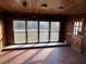 Sunroom featuring tile floors, wooden paneling, and many windows for natural light at 2117 George Winston Rd, Oxford, NC 27565