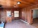Wood paneled sunroom with tile floors, a window, and a door to the outside at 2117 George Winston Rd, Oxford, NC 27565