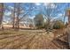Expansive backyard with mature trees and a well-maintained lawn, creating a serene outdoor environment at 2152 Haig Point Way, Raleigh, NC 27604