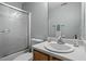 The bathroom has a glass shower door, single vanity, and large mirror at 2152 Haig Point Way, Raleigh, NC 27604