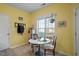 Bright breakfast nook with a small table, and a large window overlooking the backyard at 2152 Haig Point Way, Raleigh, NC 27604