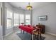 Dining area with bay windows, stylish chandelier and a red table cloth at 2152 Haig Point Way, Raleigh, NC 27604