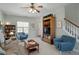 Cozy living room with a ceiling fan and plush armchairs next to the staircase at 2152 Haig Point Way, Raleigh, NC 27604
