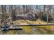 Aerial view of the lake house with a dock and boat at 220 Choctaw Dr, Louisburg, NC 27549