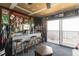 Finished basement bar area featuring a countertop, stools, exposed brick and sliding doors to deck at 220 Choctaw Dr, Louisburg, NC 27549