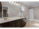 Bathroom featuring double sinks and a shower tub combo at 220 Choctaw Dr, Louisburg, NC 27549