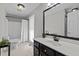 Bright bathroom with tiled floors, a large mirror, and a combined shower-tub at 220 Choctaw Dr, Louisburg, NC 27549