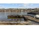 Dock with boat and furniture on the lake at 220 Choctaw Dr, Louisburg, NC 27549
