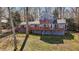 Back of blue lake house featuring two levels of decks overlooking the backyard at 220 Choctaw Dr, Louisburg, NC 27549