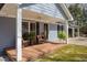 Inviting front porch with decorative plants and comfortable seating, offering a cozy entrance at 220 Choctaw Dr, Louisburg, NC 27549
