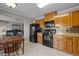 A kitchen with oak cabinets, black appliances and tiled floor at 220 Choctaw Dr, Louisburg, NC 27549