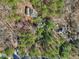 Top-down view of the house nestled in a forest, with a long driveway and lush greenery surrounding it at 2431 Winburn Ave, Durham, NC 27704