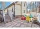 Paver patio with colorful chairs, a white picket fence, and wooded views at 2431 Winburn Ave, Durham, NC 27704