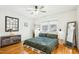 Comfortable bedroom with hardwood floors, updated furniture, ceiling fan and natural light at 2431 Winburn Ave, Durham, NC 27704