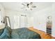 Bedroom featuring a ceiling fan, hardwood flooring, and multiple doors and closets at 2431 Winburn Ave, Durham, NC 27704