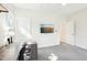 Bright bedroom with a desk and a wall-mounted TV with several entrances at 2431 Winburn Ave, Durham, NC 27704