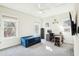 Bright bedroom featuring a desk, blue convertible sofa, and large windows with natural light at 2431 Winburn Ave, Durham, NC 27704