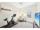 Bedroom with neutral walls, desk, stationary bike, ceiling fan and large window at 2431 Winburn Ave, Durham, NC 27704