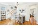 Bright dining area with hardwood floors, table with seating, and adjacent staircase at 2431 Winburn Ave, Durham, NC 27704