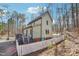 Exterior view of a two-story house with a deck, patio, and white picket fence at 2431 Winburn Ave, Durham, NC 27704