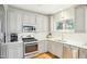Stylish kitchen featuring stainless steel appliances, grey cabinetry, and ample counter space at 2431 Winburn Ave, Durham, NC 27704