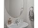 Updated bathroom featuring modern sink, fixtures, decorative soap, and an oval mirror at 3015 Cypress Lagoon Ct, Durham, NC 27703
