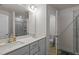 Bathroom featuring double sinks, a tile shower, and a separate toilet area at 3015 Cypress Lagoon Ct, Durham, NC 27703