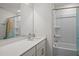 Bright bathroom featuring a shower-tub combo, extended vanity with modern white countertops, and large mirror at 3015 Cypress Lagoon Ct, Durham, NC 27703