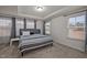 Bright bedroom featuring a large window, carpeted floor, and tray ceiling at 3015 Cypress Lagoon Ct, Durham, NC 27703