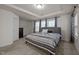 Spacious carpeted bedroom with tray ceiling, a large window and neutral color palette at 3015 Cypress Lagoon Ct, Durham, NC 27703