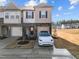 Inviting townhome with stone accents, a single-car garage, and tidy landscaping at 3015 Cypress Lagoon Ct, Durham, NC 27703