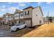 Beautiful townhome featuring stone accents, attached garage, and manicured landscaping at 3015 Cypress Lagoon Ct, Durham, NC 27703