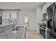 Modern kitchen featuring granite countertops, stainless steel appliances, and white cabinetry at 3015 Cypress Lagoon Ct, Durham, NC 27703
