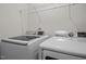 Bright laundry room with washer, dryer, and wire shelving at 3015 Cypress Lagoon Ct, Durham, NC 27703