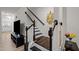 Staircase with wooden rails and decorative accents adds charm to this bright, modern home at 3015 Cypress Lagoon Ct, Durham, NC 27703