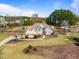 Aerial view of charming two-story home with a long driveway and well-manicured lawn at 3112 Gold Dust Ln, Willow Springs, NC 27592