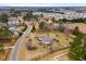 Aerial of a home and neighborhood, including a large, well-kept backyard with a wooden fence at 3112 Gold Dust Ln, Willow Springs, NC 27592
