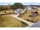 Aerial view of charming two-story home featuring a large, curved driveway and well-maintained lawn at 3112 Gold Dust Ln, Willow Springs, NC 27592