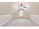 Spacious attic room features neutral paint, carpet, a ceiling fan, and a window with natural light at 3112 Gold Dust Ln, Willow Springs, NC 27592