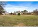 Over-sized backyard with a wooden fence, featuring a wooden pergola and storage building at 3112 Gold Dust Ln, Willow Springs, NC 27592