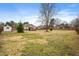 Expansive backyard with lawn, wooden fence, shed, patio with pergola, and home exterior at 3112 Gold Dust Ln, Willow Springs, NC 27592