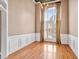 Elegant dining room featuring hardwood floors, wainscoting, a stylish chandelier, and large windows at 3112 Gold Dust Ln, Willow Springs, NC 27592