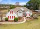 Charming two-story home with red shutters, manicured lawn and mature trees at 3112 Gold Dust Ln, Willow Springs, NC 27592