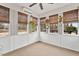 Bright sunroom with white wood paneling, neutral carpet, and many large windows with natural light at 3112 Gold Dust Ln, Willow Springs, NC 27592